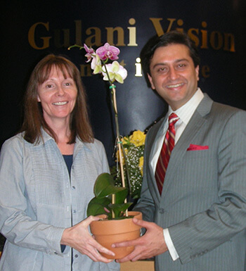 Dr. Gulani and Joanne Holding an Orchid