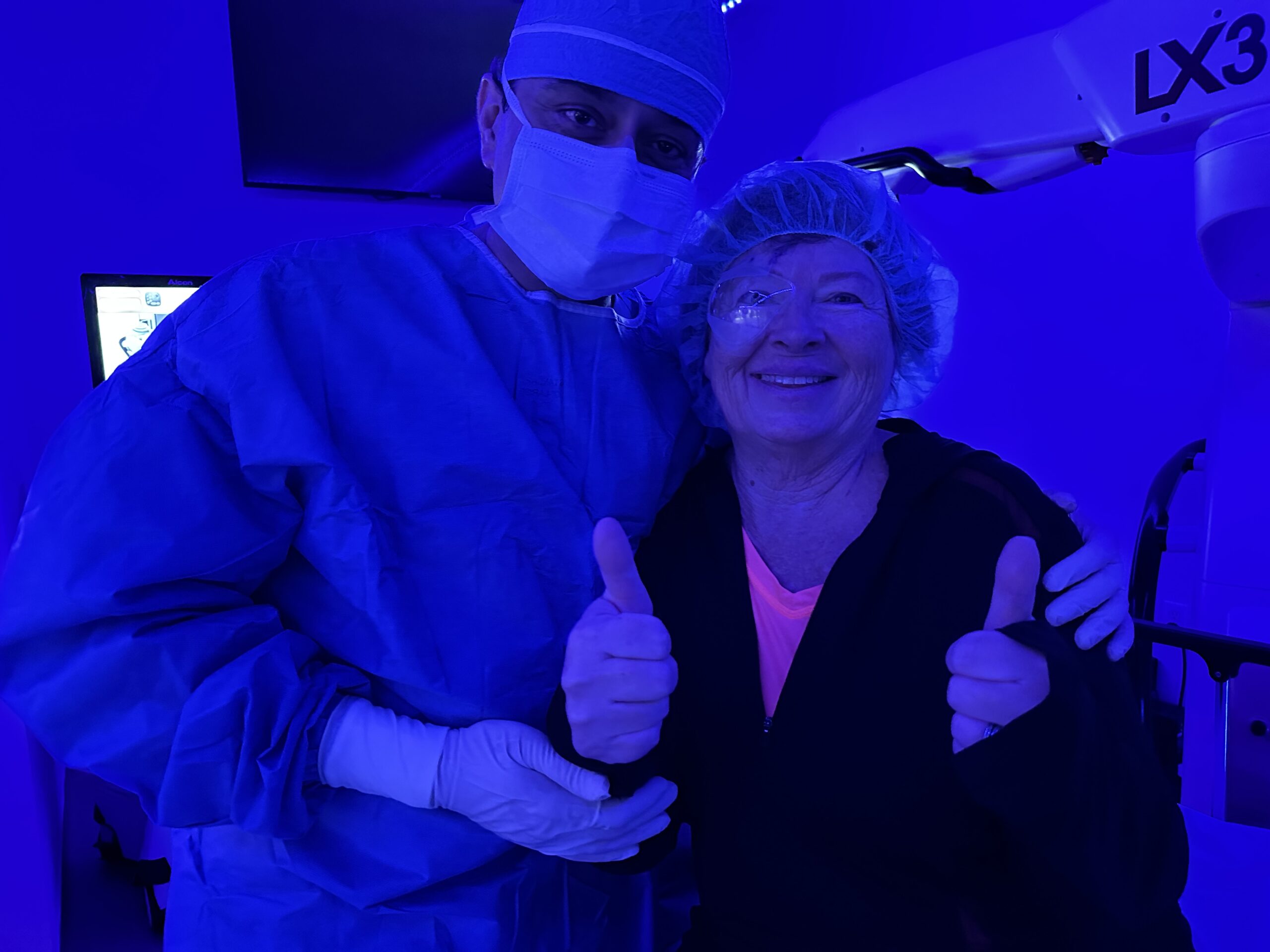 Smiling cataract surgery patient with Dr. Gulani after life-changing LenzOplastique® procedure, redefining vision correction beyond traditional cataract surgery.