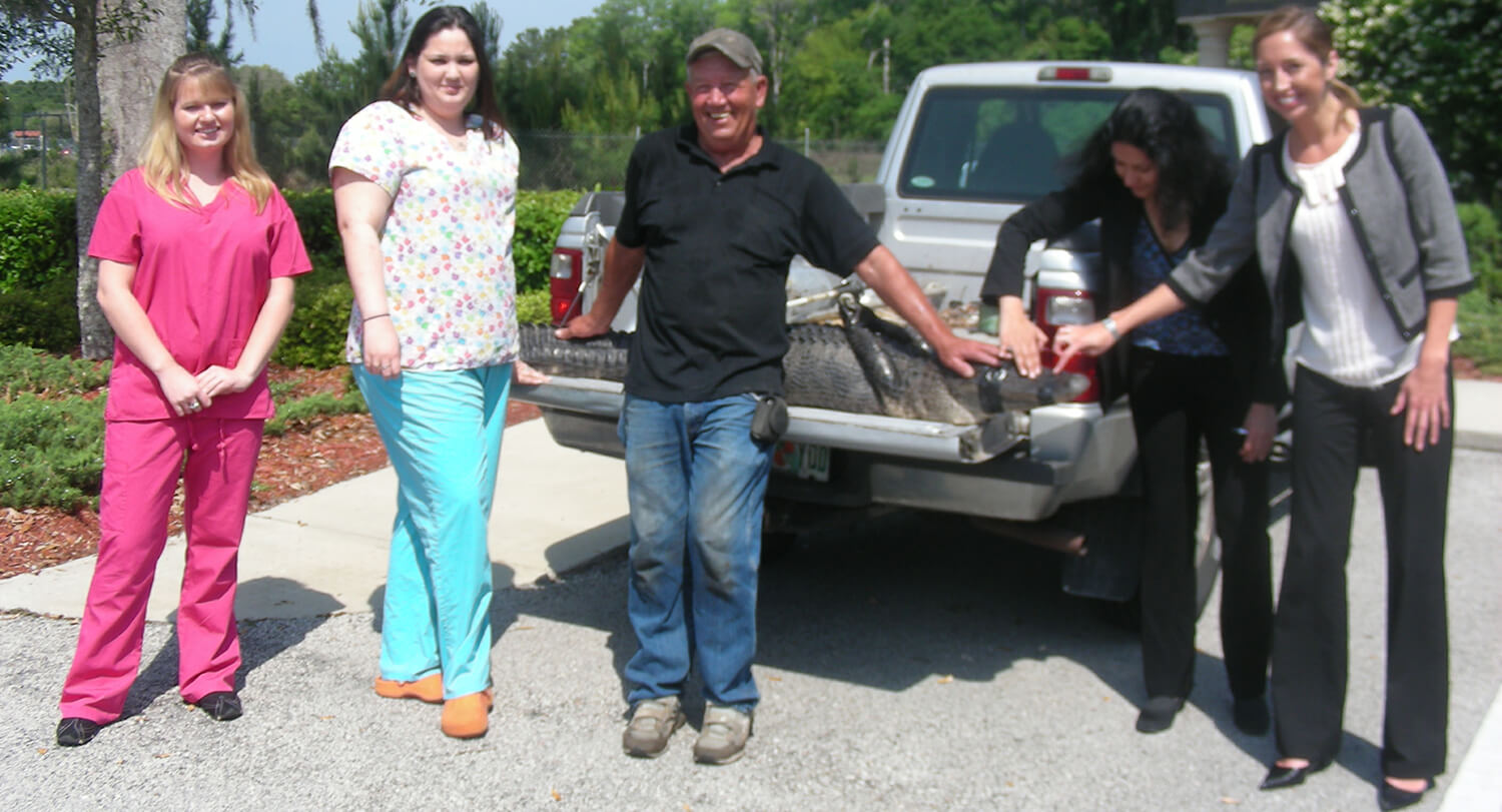 Dr. Gulani and Staff With Patient and Alligator