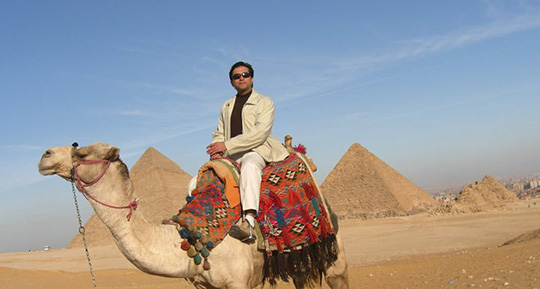 Dr. Gulani Riding a Camel in Egypt